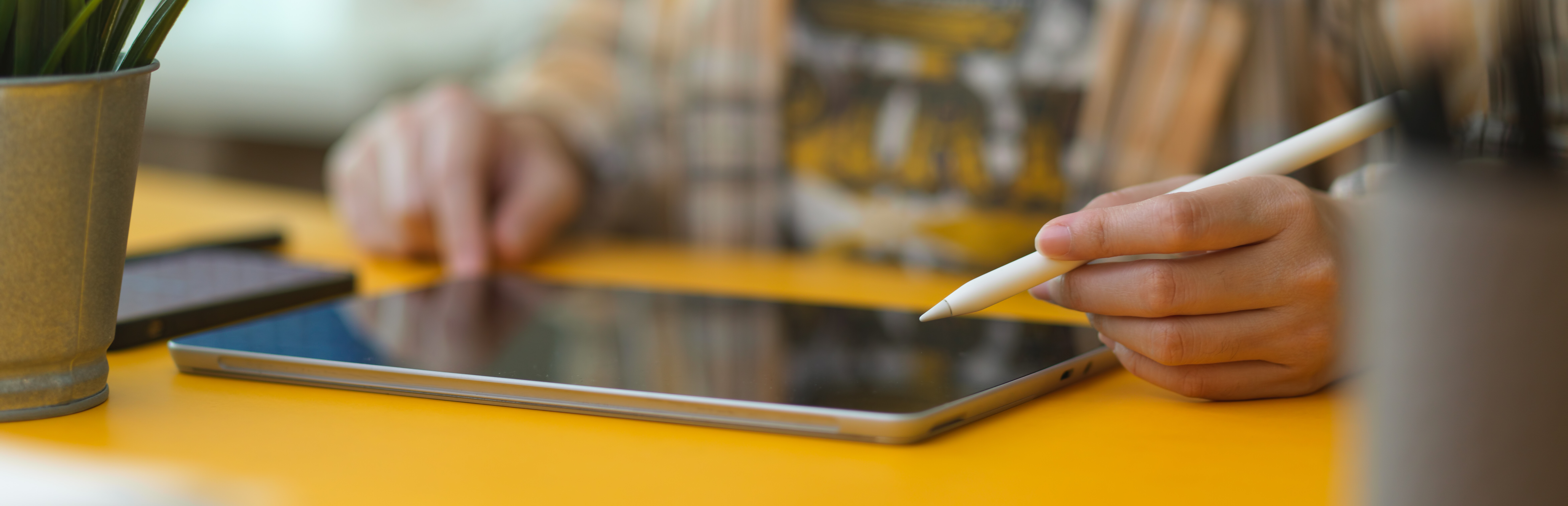 Die Hände einer Person, die ein Tablet nutzt